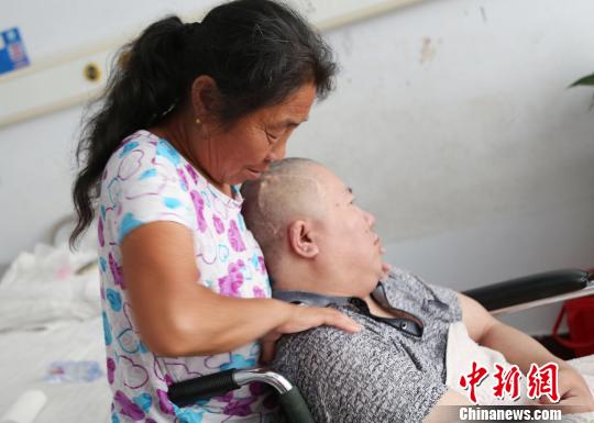 “好岳母”任增琴在為女婿高千軍做肩部按摩。胡洪濤攝