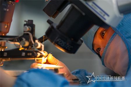 1.光芯屏端網(wǎng)產(chǎn)業(yè)集群-工作人員在顯微鏡下加工元器件.jpg
